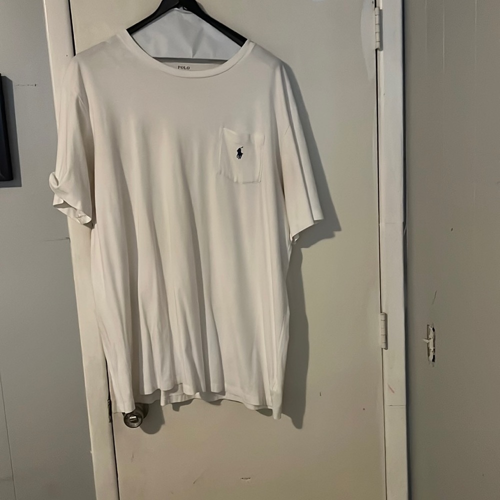 Whit polo tee with blue polo sign. Always dry cleaned and pressed.